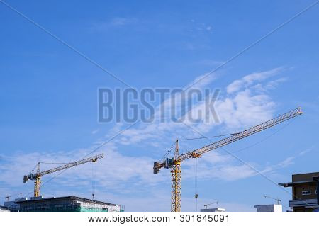 Crane And Blue Sky In Cloudy Day At A Coustruction Site