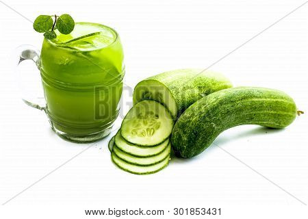 Raw Extracted Cucumber Juice In A Transparent Glass Isolated On White Along With Raw Fresh Cucumber 