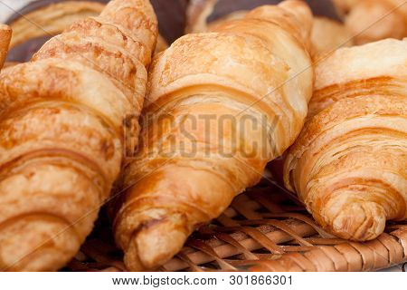 Beautiful Appetizing Croissants On A Wicker Napkin In A Cafe Or On A Storefront In A Store