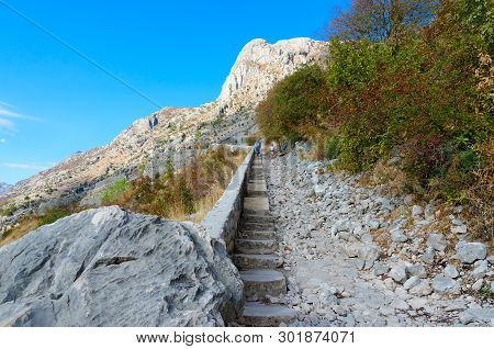 Kotor, Montenegro - September 8, 2017: Unknown Tourists Climb Stairs To Ruins Of Ancient Fortress Ab