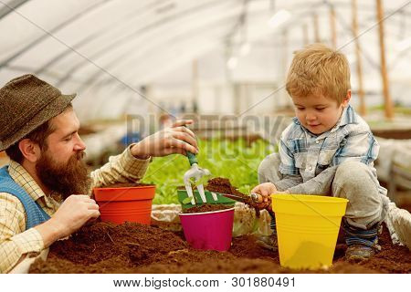 Bio Fertilizer. Father And Son Put Into The Soil Bio Fertilizer. Bio Fertilizer Production. Industry