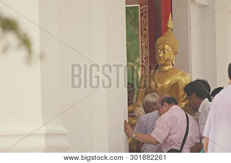 Lopburi, Thailand - 18 May 2019 - Thai Buddhist Hold The Big Buddha Statue And Someone Hold Fired Ca