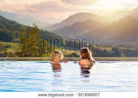 Family In Swimming Pool With Mountain View
