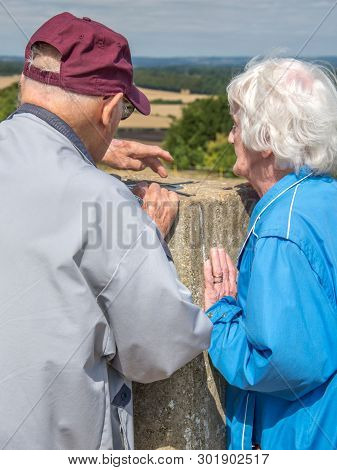 Elderly Couple Danebury Ring In The British Countryside.