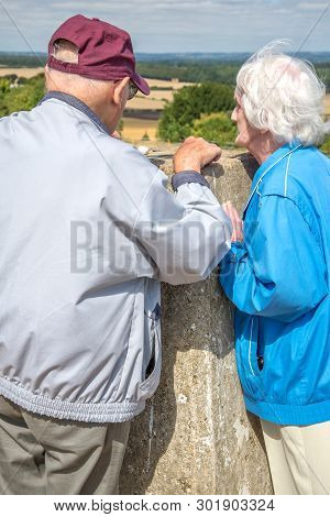 Elderly Couple In The British Countryside A Danebury Ring,wiltshire.
