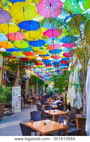 Nicosia, Cyprus - Oct 4th 2018: Outdoor Restaurant Garden With Colorful Umbrellas Decorating The Top