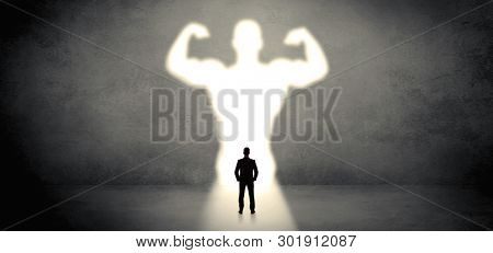 Businessman standing and dreaming about a strong superhero