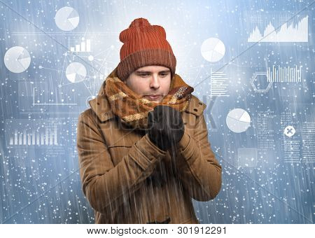 Young businessman shivering with graphs, reports and chart concept