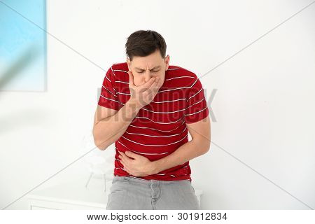 Young Man Having Nausea At Home. Feeling Sick