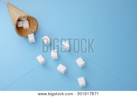Flying Sugar Cubes From Ice Cream Cone. Copy Space For Text. Top View.