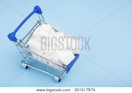 Sugar Cubes. White Sugar In The Shopping Cart On Blue Background. Buying Sugar In The Supermarket. C