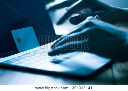 The Concept Of Credit Card Theft. Hackers With Credit Cards On Laptops Use These Data For Unauthoriz
