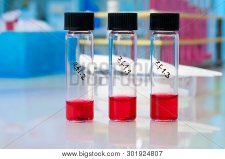 Three Liquid Samples In Plastic Vials On A Table In Biological Laboratory