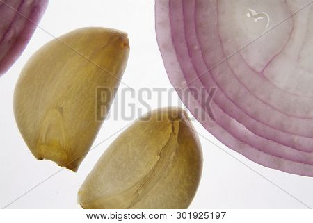 Cross Section Slice Of Red Onion And Garlic Against Light Background On Backligts