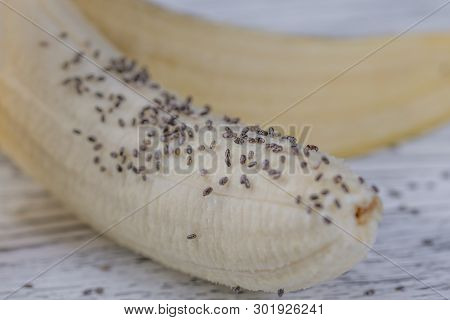 Ripe Banana With Chia Seeds On A Wooden Background