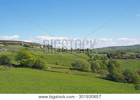A View Of The Village Of Midgley In West Yorkshire With Surrounding Green Fields And Farmhouses And 