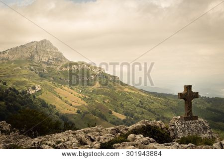 Standing Empty On Top Of A Mountain Viewpoint With A Cross In Gorbea Park. Basque Country, Spain.