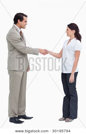 Side view of business people shaking hands against a white background