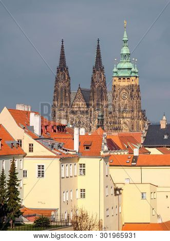 St. Vitus Cathedral And Roofs Of Old Prague With Dramatic Sky.