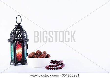 Ramadan Food And Drinks Concept. Ramadan Lantern With Arabian Lamp, Wood Rosary, Tea, Dates Fruit An