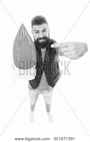 Household Ironing. Bearded Man Pointing At Clothes Iron. Hipster Presenting Electric Ironing Tool. U