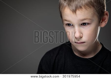 Grief-stricken little boy - feeling intense sorrow, remorse, sadnesss - studio portrait - vivid emotions series