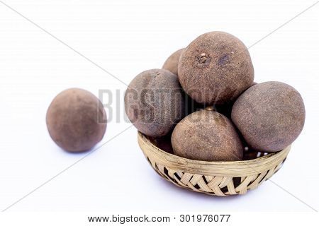 Raw Chikoo Or Sapodilla Isolated On White In A Basket.