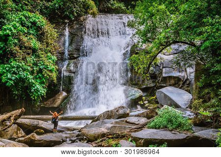 Women Travel. Woman Asia Travelers Travel Nature Forests, Mountains, Waterfalls. Travel Siliphum Wat