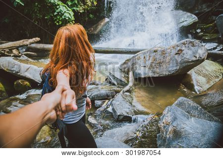 Male And Woman Couples Asia. Walking Hand Travelers Travel Nature Forests, Mountains, Waterfalls. Tr