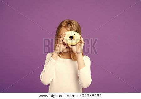 Sweet Mood. Child Look In Donut On Violet Background. Little Girl With Glazed Ring Doughnut On Purpl