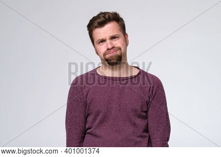 Tired Caucasian Man With Beard Puffing His Cheeks.