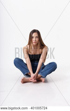 Young Attractive Asian Woman With Long Hair In Black Top, Blue Jeans Isolated On White Studio Backgr
