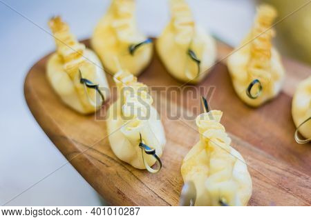 Baked Dough With Cottage Cheese On A Skewer. Mini Snack In The Form Of A Dumpling On The Board.