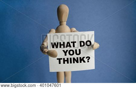 The Wooden Man Holds A White Sign With The Text Whatdoyou Think In His Hands. The Content Of The Let