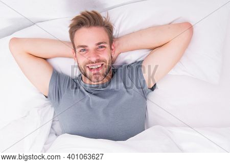 New Smile, New Day. Happy Man Awaken In Bed. Handsome Caucasian Man With Happy Smile Relaxing In The