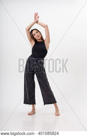 Portrait Of Young Attractive Asian Woman With Long Hair In Black Body, Jeans, Isolated On White Stud