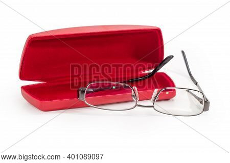 Modern Eyeglasses In Metal Gray Rim With Open Temples Against The Red Hard Spectacle-case On A White