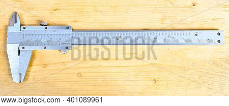 Caliper With Centimeter And Millimeter On Wooden Bench