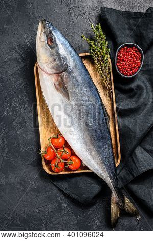 Fresh Whole Raw Japanese Yellowtail With Tomato And Herbs. Fish Amberjack. Black Background. Top Vie