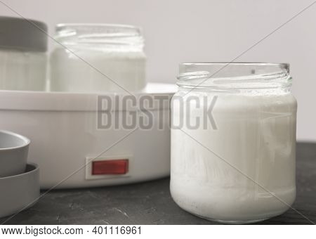 Homemade Organic Yogurt In Glass Jars Near Yogurt Maker. Automatic Yogurt Machine To Make Fermented 