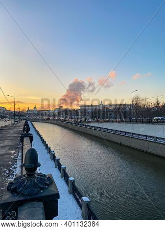 Moscow River Embarkment At Dusk. Blue Sky. Steam