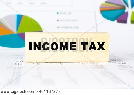 Word Income Tax. Wooden Small Cubes With Letters With Copy Space Available. Business Concept Image.