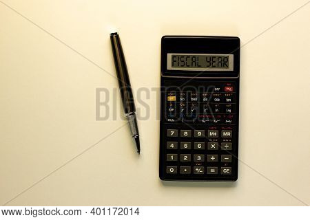 Fiscal Year Symbol. Calculator With Words 'fiscal Year', Metalic Pen. Business And Fiscal Year Conce