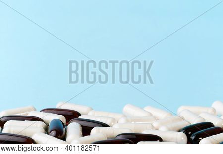 Medicine Or Supplement Capsules On Blue Surface. Pharmaceutical Pills And Vitamins. Probiotic, Gluco