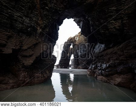 Massive Natural Arches Visible At Praia As Catedrais Cathedrals Beach Near Ribadeo Galicia In Spain 