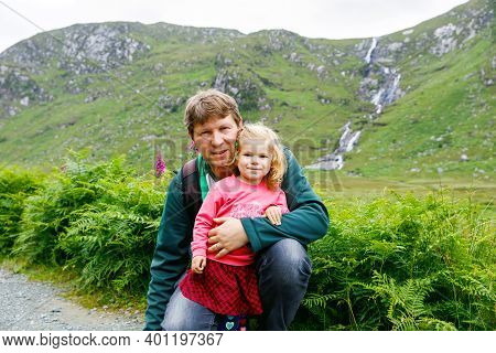 Little Happy Toddler Girl Hugging With Father In Glenveagh National Park In Ireland. Smiling And Lau