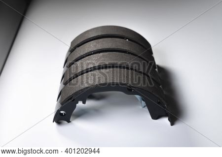 New Set Of Four Brake Pads For Drum Brakes On A Gray Background