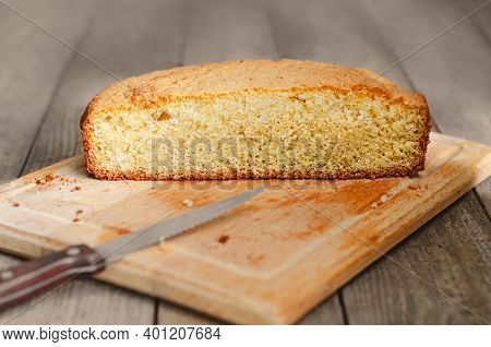 Half Of A Homemade Biscuit On A Defocused Wooden Background, Tinted Image In Rustic Style. Selective