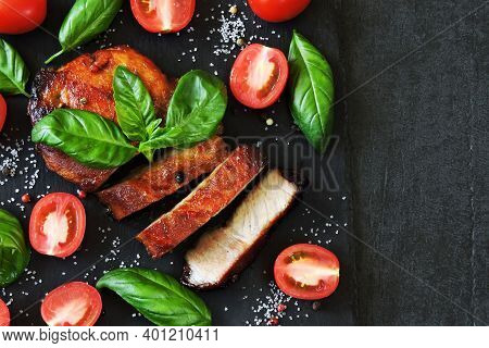 Appetizing Meat Steak On A Stone Board With Basil And Tomatoes. Keto Diet. Pegan Diet. Paleo Diet.