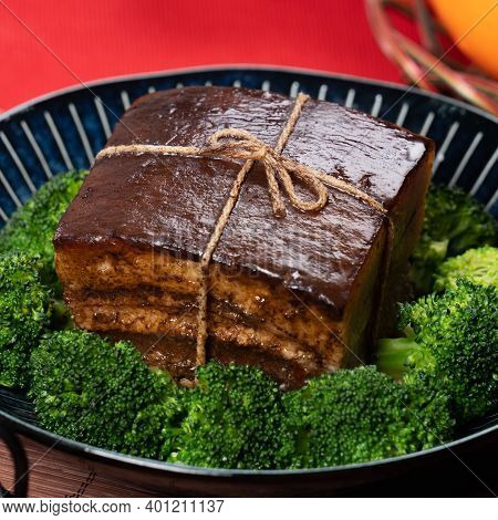 Dong Po Pork Meat In A Blue Plate With Broccoli With Red Background.